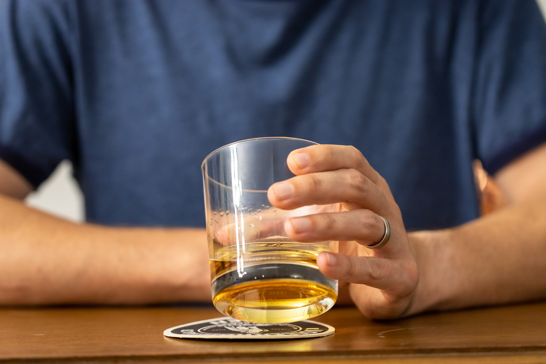 Man Drinking a Glass of Whiskey at a Bar